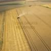 Photos aériennes de "sillon" - Photo réf. N001393 - La moissonneuse-batteuse au milieu des champs.