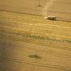 Photos aériennes de "sillon" - Photo réf. N001394 - La moissonneuse-batteuse au milieu des champs.