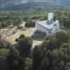 Photos aériennes de "la-haut" - Photo réf. N017813 - Construite en 1955 par Le Corbusier, la chapelle de Ronchamp ou la chapelle Notre-Dame du Haut attire de nombreux visiteurs avec sa forme atypique.