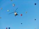 Photos aériennes de "travail" - Photo réf. E145963 - L'hlicoptre de l'Europe vue du ciel en plein travail de prises de vues ariennes autour des montgolfires du Mondial Air Ballons 2013.
