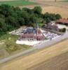 Photos aériennes de "vernissées" - Photo réf. 703379 - L'église du XIè et XIIIè siècle avec un toit en tuiles vernissées et son cimetière