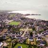 Photos aériennes de "stade" - Photo réf. 780013 - Vue d'ensemble de Erquy avec le stade en bordure de mer.