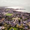 Photos aériennes de "AVEC" - Photo réf. 780013 - Vue d'ensemble de Erquy avec le stade en bordure de mer.