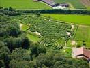 Photos aériennes de "labyrinthe" - Photo réf. T099682 - La Ferme Aventure située dans les Vosges propose des parcours ludiques et pédagogiques dans différents labyrinthes de maïs, bois, pierre et céréales.