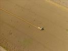 Photos aériennes de "céréalière" - Photo réf. E124509 - Une moissonneuse batteuse au travail.