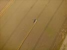 Photos aériennes de "céréalière" - Photo réf. E124511 - Une moissonneuse batteuse au travail.
