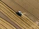 Photos aériennes de "moissonneuse" - Photo réf. E124518 - Une moissonneuse batteuse au travail.