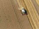 Photos aériennes de "cereales" - Photo réf. E124520 - Une moissonneuse batteuse au travail.