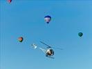 Photos aériennes de "photo" - Photo réf. E145958 - L'hélicoptère de l'Europe vue du ciel en plein travail de prises de vues aériennes autour des montgolfières du Mondial Air Ballons 2013.